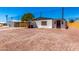 Charming home featuring a low maintenance yard, complemented by desert landscaping and mature shade tree at 7442 E Baseline Rd, Mesa, AZ 85209