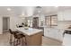 Bright kitchen featuring quartz countertops, modern appliances, and an island with seating, perfect for casual dining at 7442 E Baseline Rd, Mesa, AZ 85209