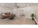 Well-lit living room with hardwood floors, a plush sofa, and an open floor plan that creates an inviting atmosphere at 7442 E Baseline Rd, Mesa, AZ 85209