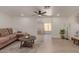 Bright living room with hardwood floors, comfortable seating, a decorative rug, and a view into an adjacent room at 7442 E Baseline Rd, Mesa, AZ 85209