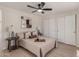 Serene bedroom with neutral tones, two closets, a ceiling fan, and side tables with lamps providing a relaxing atmosphere at 7442 E Baseline Rd, Mesa, AZ 85209