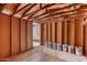 Spacious interior shed with a sturdy wood frame with paint cans for future projects and storage at 7442 E Baseline Rd, Mesa, AZ 85209