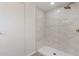 Updated walk-in shower featuring marble-look tile, rainfall shower head, and modern fixtures at 7442 E Baseline Rd, Mesa, AZ 85209