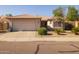 Cozy single-Gathering home showcasing a well maintained front yard and a spacious two-car garage at 8952 W Monte Vista Rd, Phoenix, AZ 85037