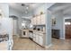 View of the kitchen featuring white cabinets and appliances, and an adjoining dining area at 8952 W Monte Vista Rd, Phoenix, AZ 85037