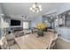Spacious open concept living room and dining area, with high ceilings and view to the kitchen at 8952 W Monte Vista Rd, Phoenix, AZ 85037