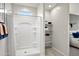 Bright bathroom with a white shower, storage shelves, and view to the bedroom at 9943 S Desert View Dr, Apache Junction, AZ 85120