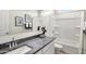 Clean bathroom featuring a granite countertop, full tub, and contemporary black and white accents at 9943 S Desert View Dr, Apache Junction, AZ 85120