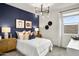Modern bedroom with a navy accent wall, stylish chandelier, and cozy decor at 9943 S Desert View Dr, Apache Junction, AZ 85120