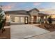 New single-story home featuring a well-maintained lawn, neutral color scheme and a covered porch at 9943 S Desert View Dr, Apache Junction, AZ 85120