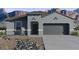 Inviting single-story home featuring a gray exterior, neutral trim, desert landscaping, and a two-car garage at 9943 S Desert View Dr, Apache Junction, AZ 85120