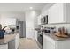 Well-lit kitchen with modern appliances, including a stainless steel refrigerator and built-in microwave at 9943 S Desert View Dr, Apache Junction, AZ 85120