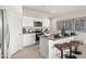 Bright kitchen with granite countertops, white cabinets, and a center island with bar stool seating at 9943 S Desert View Dr, Apache Junction, AZ 85120