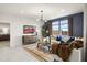 Bright living room with stylish decor, modern lighting, and large windows at 9943 S Desert View Dr, Apache Junction, AZ 85120