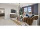 Bright living room with stylish decor, modern lighting, and large windows at 9943 S Desert View Dr, Apache Junction, AZ 85120