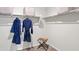 Bright walk-in closet with shelves, hanging rods, and a stool with a towel at 9943 S Desert View Dr, Apache Junction, AZ 85120