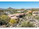 Beautiful desert home featuring a private pool and lush landscaping with desert mountain views at 10531 E Cinder Cone Trl, Scottsdale, AZ 85262