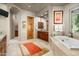 Luxury bathroom with dual vanities, spa tub, travertine tile flooring, and private commode at 10531 E Cinder Cone Trl, Scottsdale, AZ 85262
