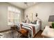 Bright bedroom featuring two twin beds, a window with shutters, and stylish decorative accents at 10531 E Cinder Cone Trl, Scottsdale, AZ 85262