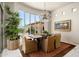 Elegant dining room with a chandelier, large windows, and comfortable seating offers a sophisticated dining experience at 10531 E Cinder Cone Trl, Scottsdale, AZ 85262