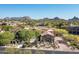 Stunning view of a desert home showcasing clay tile roof and beautiful desert landscaping at 10531 E Cinder Cone Trl, Scottsdale, AZ 85262