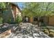 Inviting desert home entrance featuring a stone and stucco exterior and desert landscaping at 10531 E Cinder Cone Trl, Scottsdale, AZ 85262