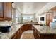 Stylish kitchen with granite countertops, custom cabinetry, and a view to the dining area provides ample space for cooking at 10531 E Cinder Cone Trl, Scottsdale, AZ 85262