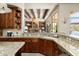 Well-appointed kitchen with granite counters, stainless steel appliances, and a view of the living room and pool at 10531 E Cinder Cone Trl, Scottsdale, AZ 85262