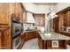 Gourmet kitchen featuring stainless steel appliances, granite counters, and custom cabinets offers modern convenience at 10531 E Cinder Cone Trl, Scottsdale, AZ 85262