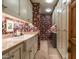 Charming laundry room with utility sink, custom wallpaper, and plentiful storage at 10531 E Cinder Cone Trl, Scottsdale, AZ 85262
