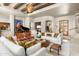 Bright living room with beamed ceilings, elegant furnishings, and a grand piano exudes luxury and sophistication at 10531 E Cinder Cone Trl, Scottsdale, AZ 85262