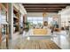 Bright living room with travertine floors, wood beams, modern decor, and a desert view at 10531 E Cinder Cone Trl, Scottsdale, AZ 85262