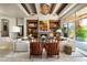 Spacious living room featuring travertine floors, wood beams, modern decor, and fireplace at 10531 E Cinder Cone Trl, Scottsdale, AZ 85262
