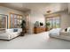 Bright main bedroom boasting hardwood shutters and gorgeous views of the surrounding desert landscape at 10531 E Cinder Cone Trl, Scottsdale, AZ 85262