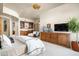 Spacious main bedroom featuring built-in cabinetry and a gorgeous recessed ceiling with decorative chandelier at 10531 E Cinder Cone Trl, Scottsdale, AZ 85262