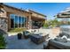 Outdoor living area with seating, fire pit, grill, and lush landscaping at 10531 E Cinder Cone Trl, Scottsdale, AZ 85262