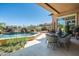 Outdoor living space with dining area, swimming pool, and desert landscaping at 10531 E Cinder Cone Trl, Scottsdale, AZ 85262