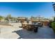Outdoor patio area with seating, desert landscaping, and a swimming pool at 10531 E Cinder Cone Trl, Scottsdale, AZ 85262