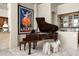 Elegant piano room features a grand piano, stylish decor, and unique architectural details, perfect for music lovers at 10531 E Cinder Cone Trl, Scottsdale, AZ 85262