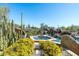 Inviting pool and spa area features lush desert landscaping and boulder accents with a stunning natural backdrop at 10531 E Cinder Cone Trl, Scottsdale, AZ 85262