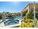 Backyard oasis features a pool and spa surrounded by desert landscaping and a well-appointed exterior at 10531 E Cinder Cone Trl, Scottsdale, AZ 85262