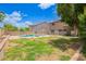A spacious backyard features a private pool area surrounded by greenery, with secure fencing at 10566 E Bogart Ave, Mesa, AZ 85208