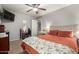 Bedroom with neutral walls, carpet, a ceiling fan, TV, and comfortable decor at 10566 E Bogart Ave, Mesa, AZ 85208