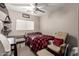 A comfortable bedroom features carpet flooring, a small crib, and a chair with a pillow at 10566 E Bogart Ave, Mesa, AZ 85208