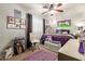 A playful bedroom features a plush rug, stylish chair, and unique purple decorations and bedding at 10566 E Bogart Ave, Mesa, AZ 85208