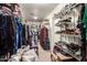 Walk-in closet with ample storage space, shelving, and hanging rods for clothes and shoes at 10566 E Bogart Ave, Mesa, AZ 85208