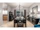 Elegant dining room featuring a large table with seating for ten, decorative lighting, and stylish furnishings at 10566 E Bogart Ave, Mesa, AZ 85208
