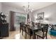 Stylish dining room featuring a large table, elegant chandelier, and tasteful decor, perfect for entertaining at 10566 E Bogart Ave, Mesa, AZ 85208