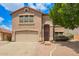 Charming two-story home featuring a well-maintained lawn, a two-car garage, and a welcoming entrance at 10566 E Bogart Ave, Mesa, AZ 85208