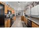 Well-equipped kitchen with wooden cabinetry, granite countertops, and modern appliances, ideal for cooking enthusiasts at 10566 E Bogart Ave, Mesa, AZ 85208